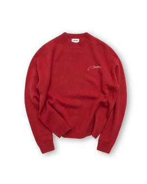 Red sweater with a brand logo on a white background