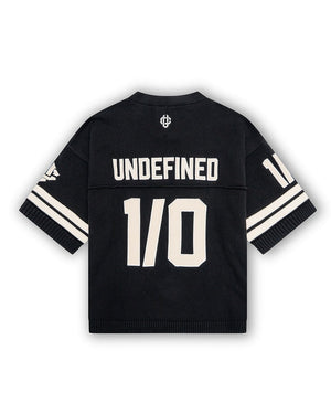 Black sports jersey with 'UNDEFINED' and '1/0' text on a white background