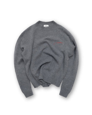 Gray sweater with a small red logo on a white background